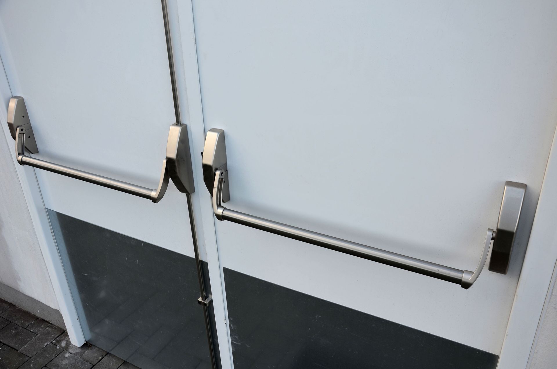 A close up of a door with a panic bar on it