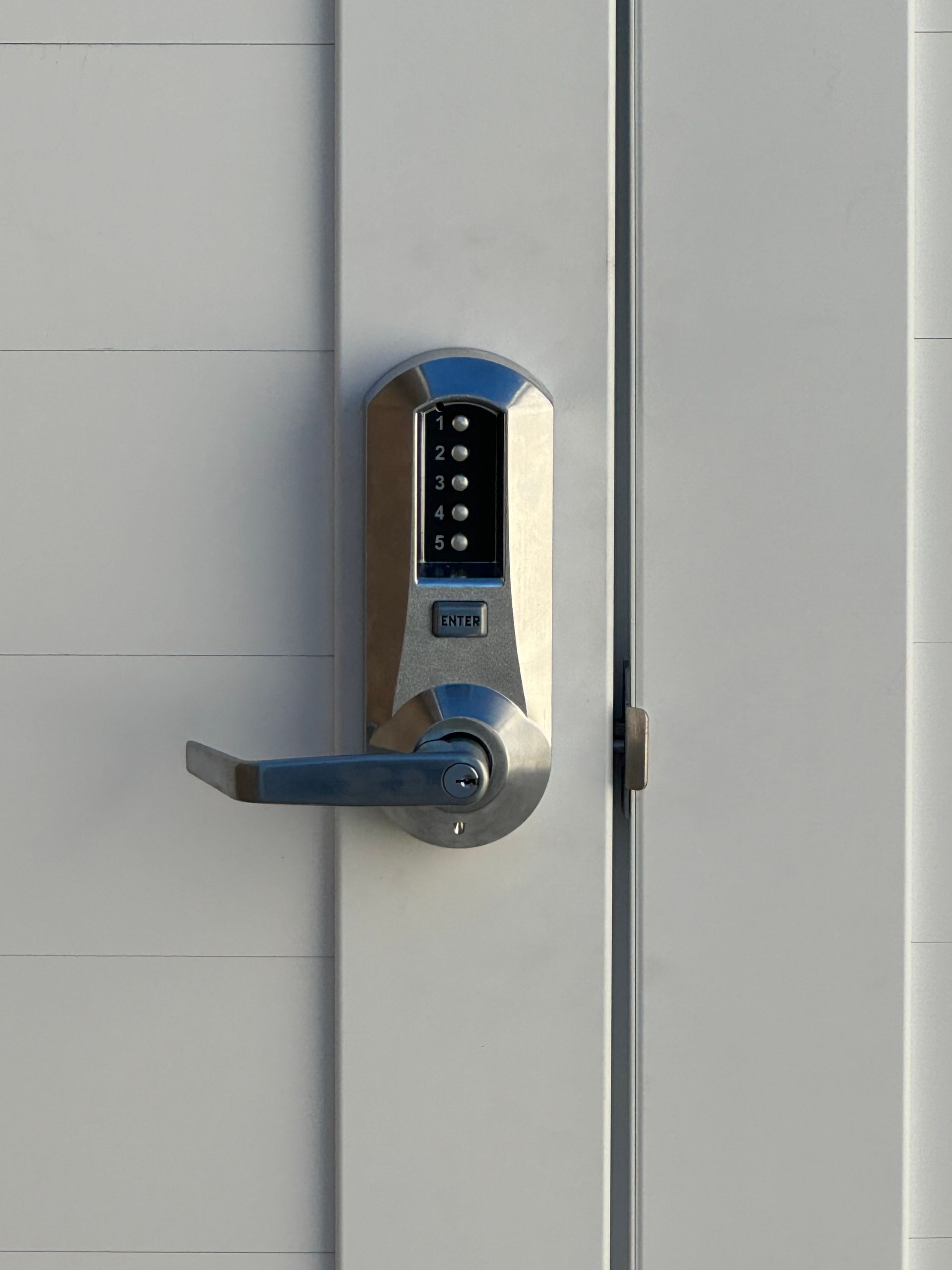 A close up of a door lock on a white door.