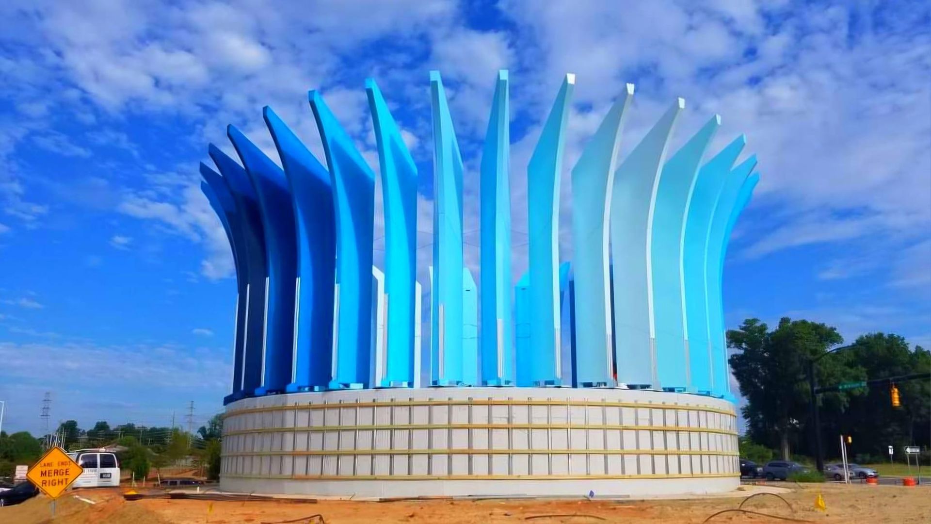 Blue, abstract sculpture with vertical elements.