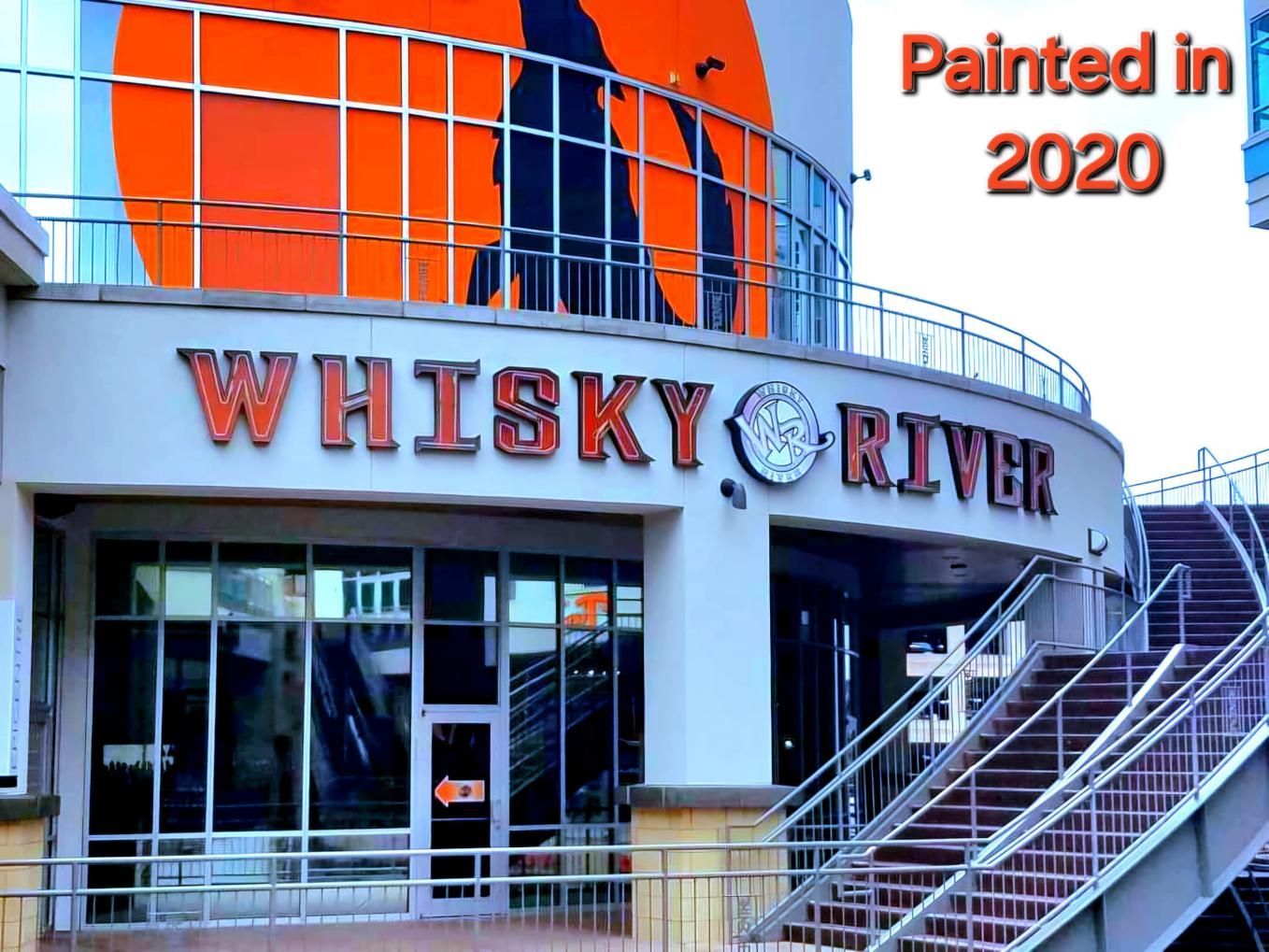 Whisky River bar exterior with orange signage.