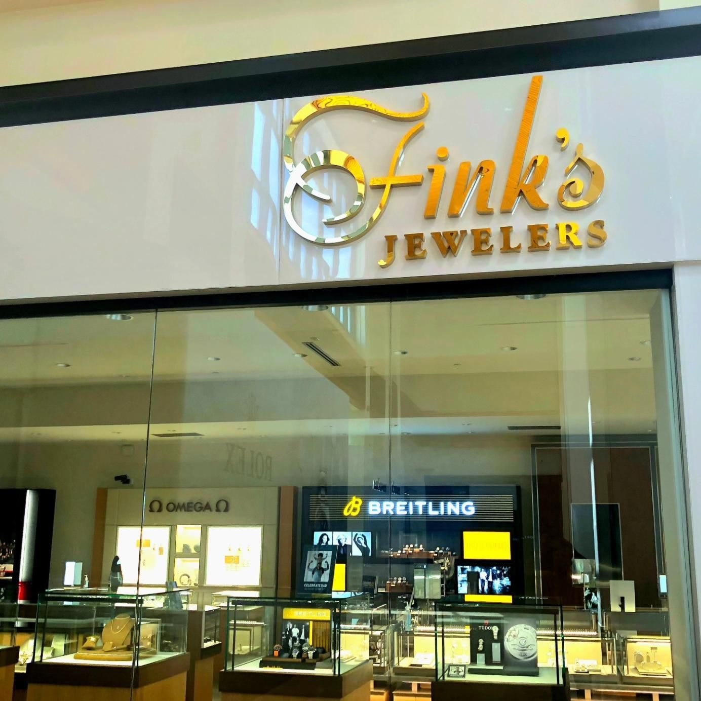 Fink's Jewelers store front, gold lettering on white.