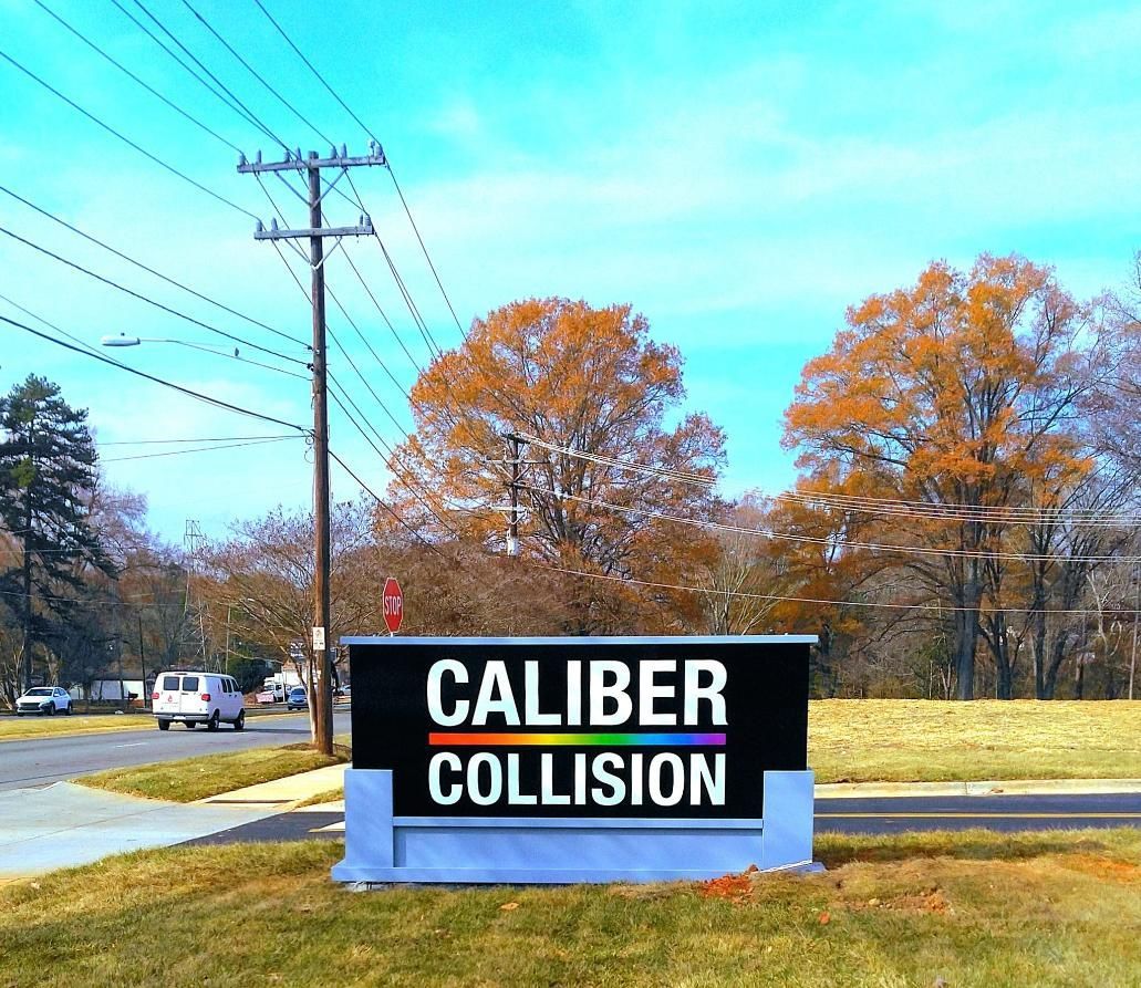 Caliber Collision sign with colorful logo.
