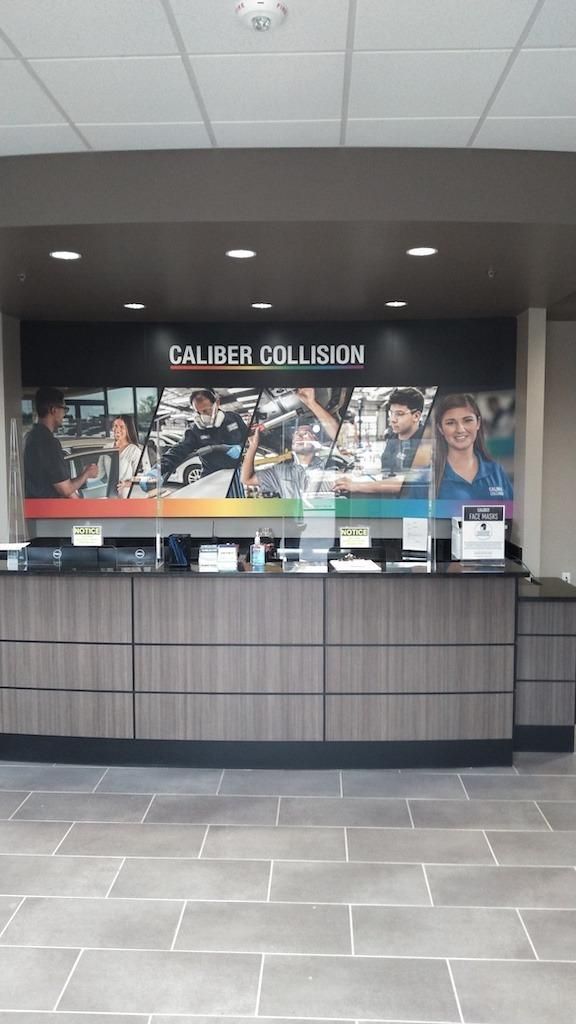 Caliber Collision front desk with signage. 