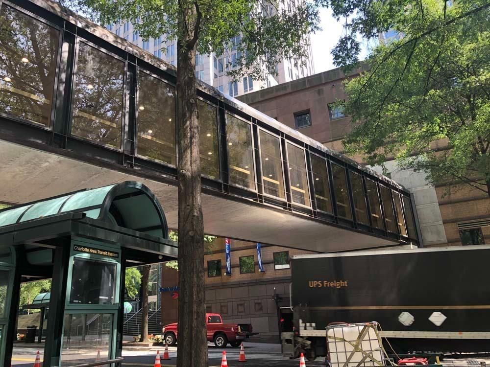 Pedestrian bridge over street; UPS freight truck parked below.