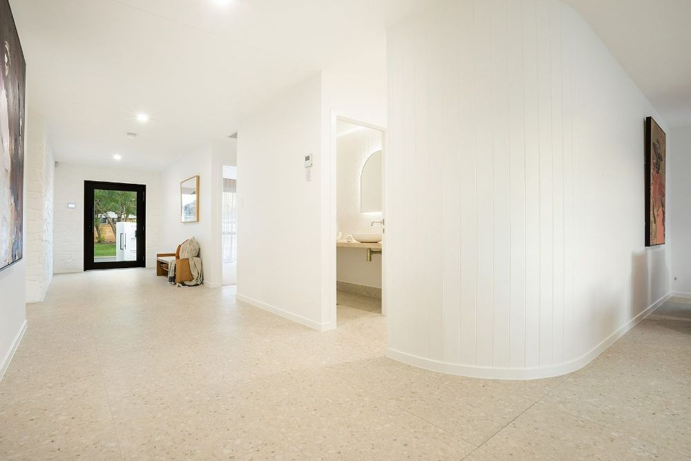  Long Hallway With White Walls and Beige Carpet Leading to a Bathroom — Beith Building & Developments Pty Ltd In Burleigh Heads, QLD