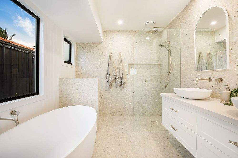 Bathroom With a Bathtub , Sink , Mirror and Walk in Shower — Beith Building & Developments Pty Ltd In Burleigh Heads, QLD