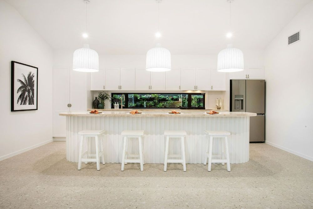 Kitchen With a Large Island , Stools and a Refrigerator — Beith Building & Developments Pty Ltd In Burleigh Heads, QLD