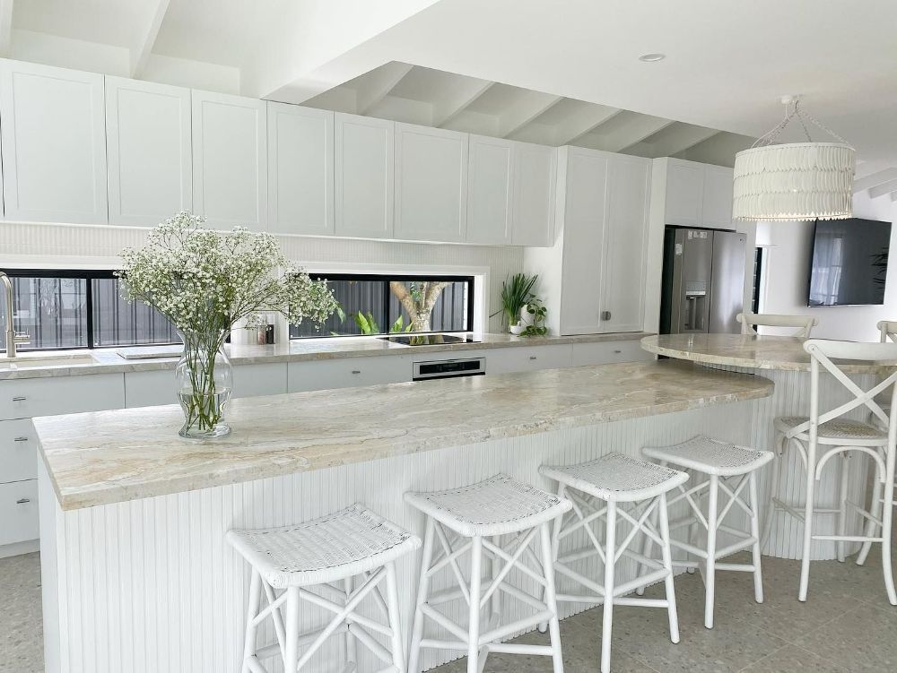 A Kitchen with A Large Island and White Stools — Beith Building & Developments Pty Ltd In Hope Island, QLD
