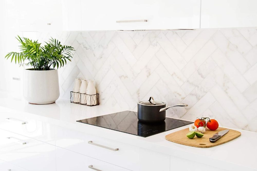 A Kitchen with A Pot on The Stove and A Cutting Board — Beith Building & Developments Pty Ltd In Broadbeach, QLD