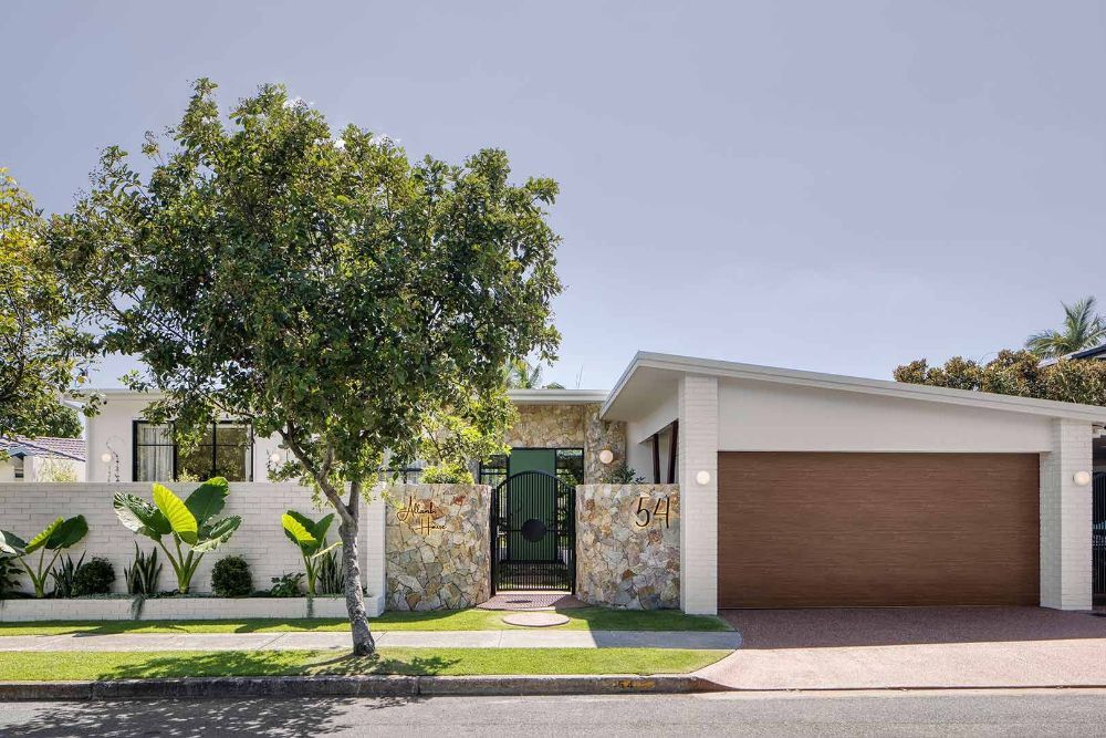  White House With a Brown Garage Door and a Tree in Front of It — Beith Building & Developments Pty Ltd In Burleigh Heads, QLD