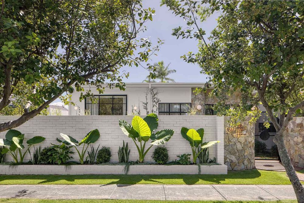 White House With a Brick Wall and Plants in Front of It — Beith Building & Developments Pty Ltd In Burleigh Heads, QLD