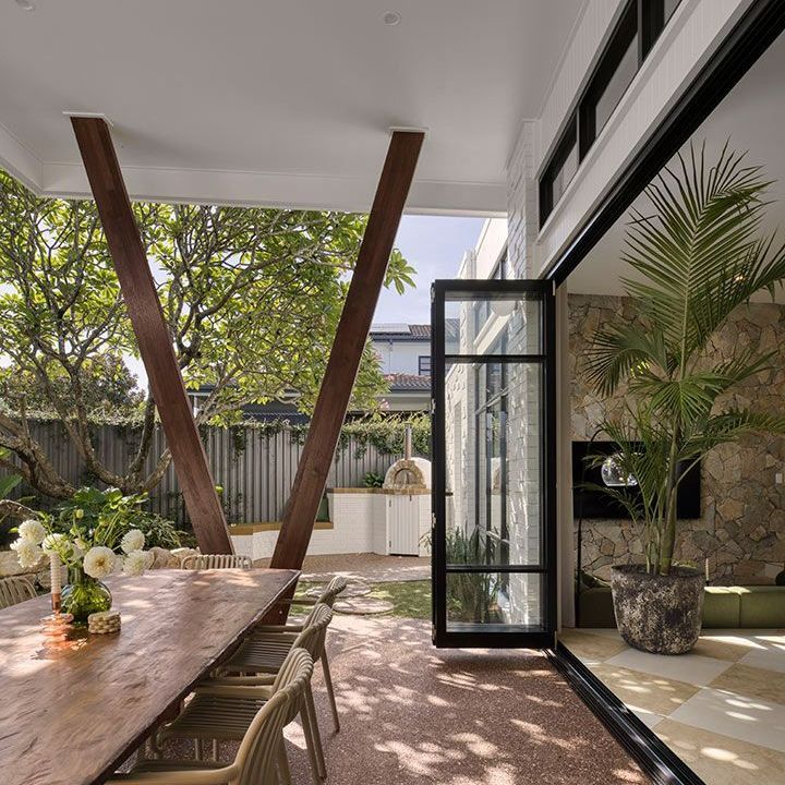 Patio With a Wooden Table and Chairs and a Sliding Glass Door — Beith Building & Developments Pty Ltd In Burleigh Heads, QLD
