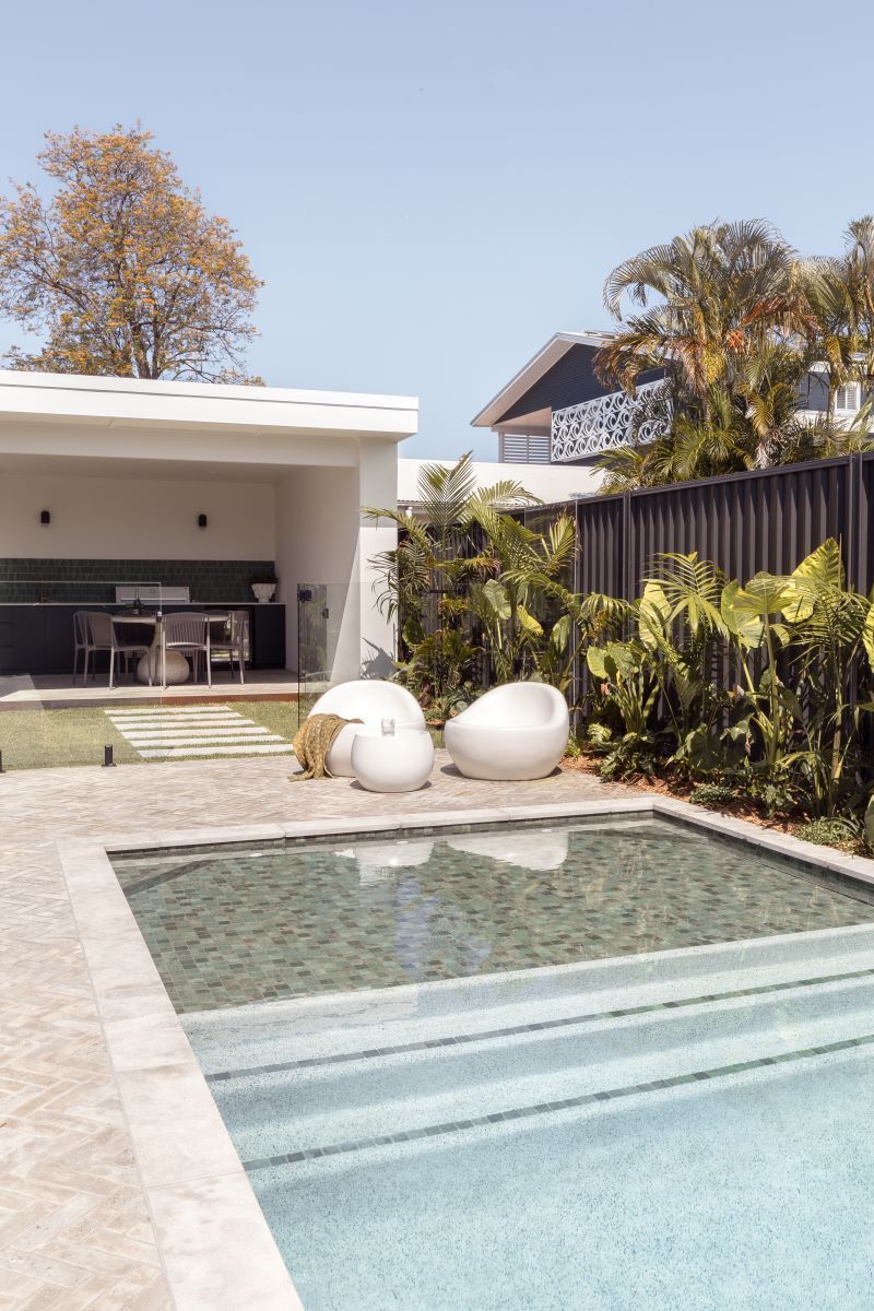 A Large Swimming Pool in the Backyard of a House — Beith Building & Developments Pty Ltd in Burleigh Heads, Qld