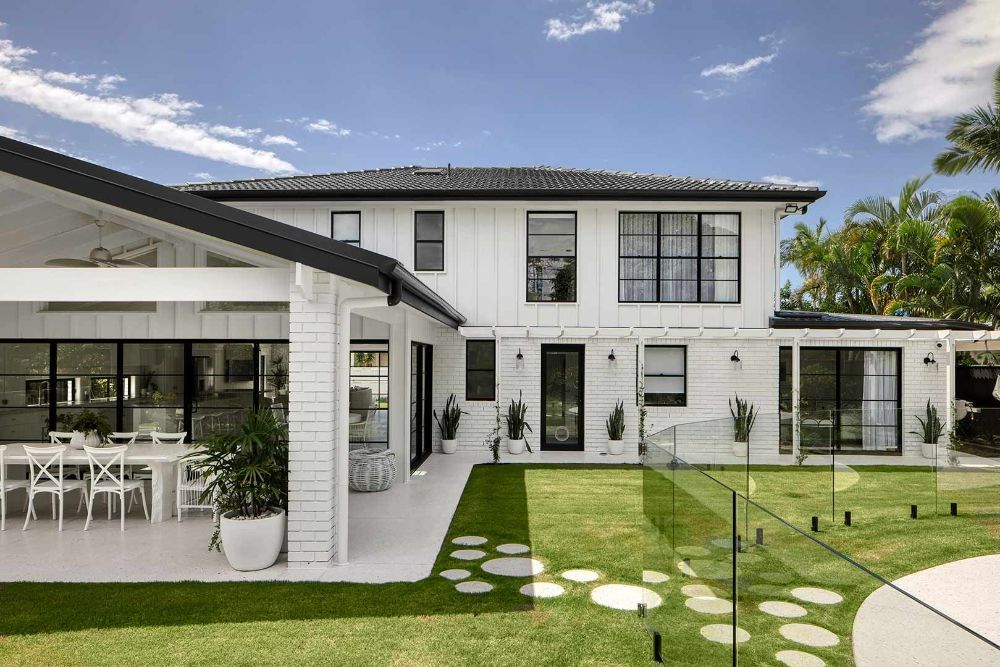 Large White House With Black Windows and a Large Lawn in Front of It — Beith Building & Developments Pty Ltd In Burleigh Heads, QLD