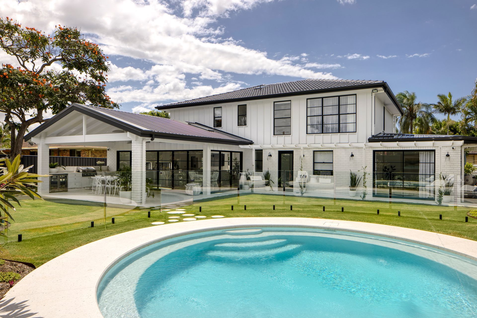 Large White House With a Swimming Pool in Front of It — Beith Building & Developments Pty Ltd In Burleigh Heads, QLD