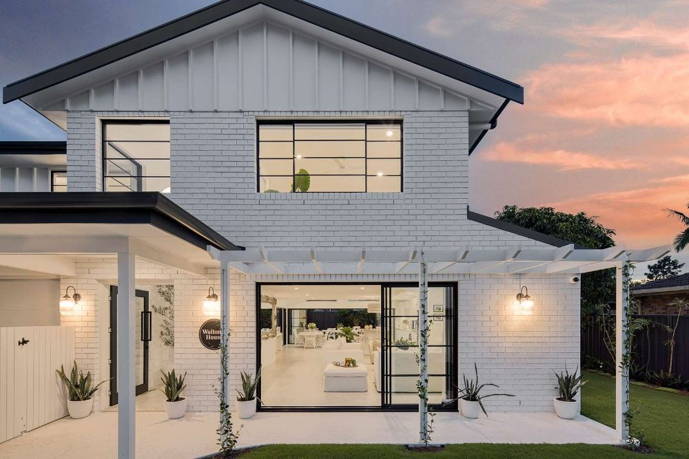 White House With a Black Roof is Sitting on Top of a Lush Green Lawn — Beith Building & Developments Pty Ltd In Burleigh Heads, QLD