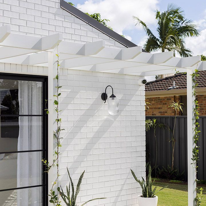 White Brick Building With a Pergola and a Window — Beith Building & Developments Pty Ltd In Burleigh Heads, QLD