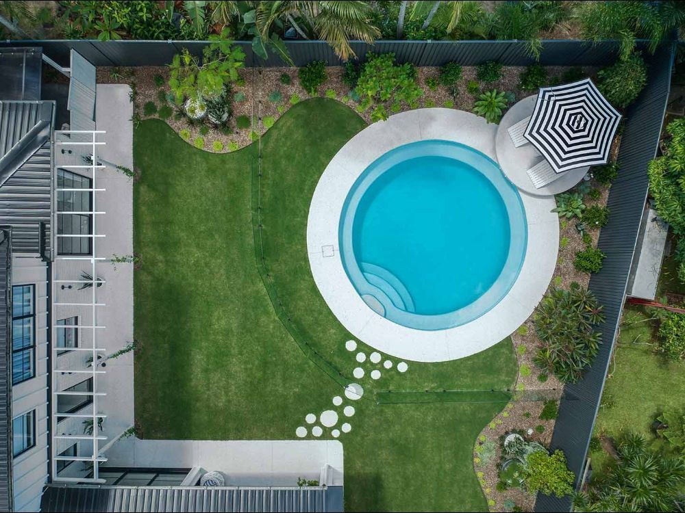 An Aerial View of a Swimming Pool in the Backyard of a House — Beith Building & Developments Pty Ltd In Burleigh Heads, QLD