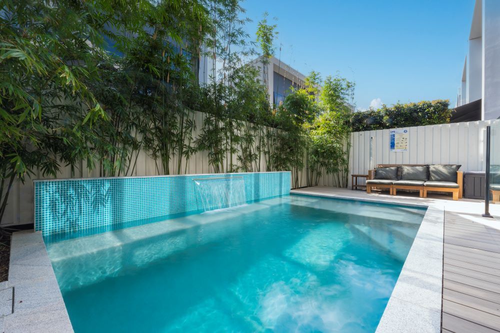 A Large Swimming Pool in the Backyard of a House — Beith Building & Developments Pty Ltd In Burleigh Heads, QLD