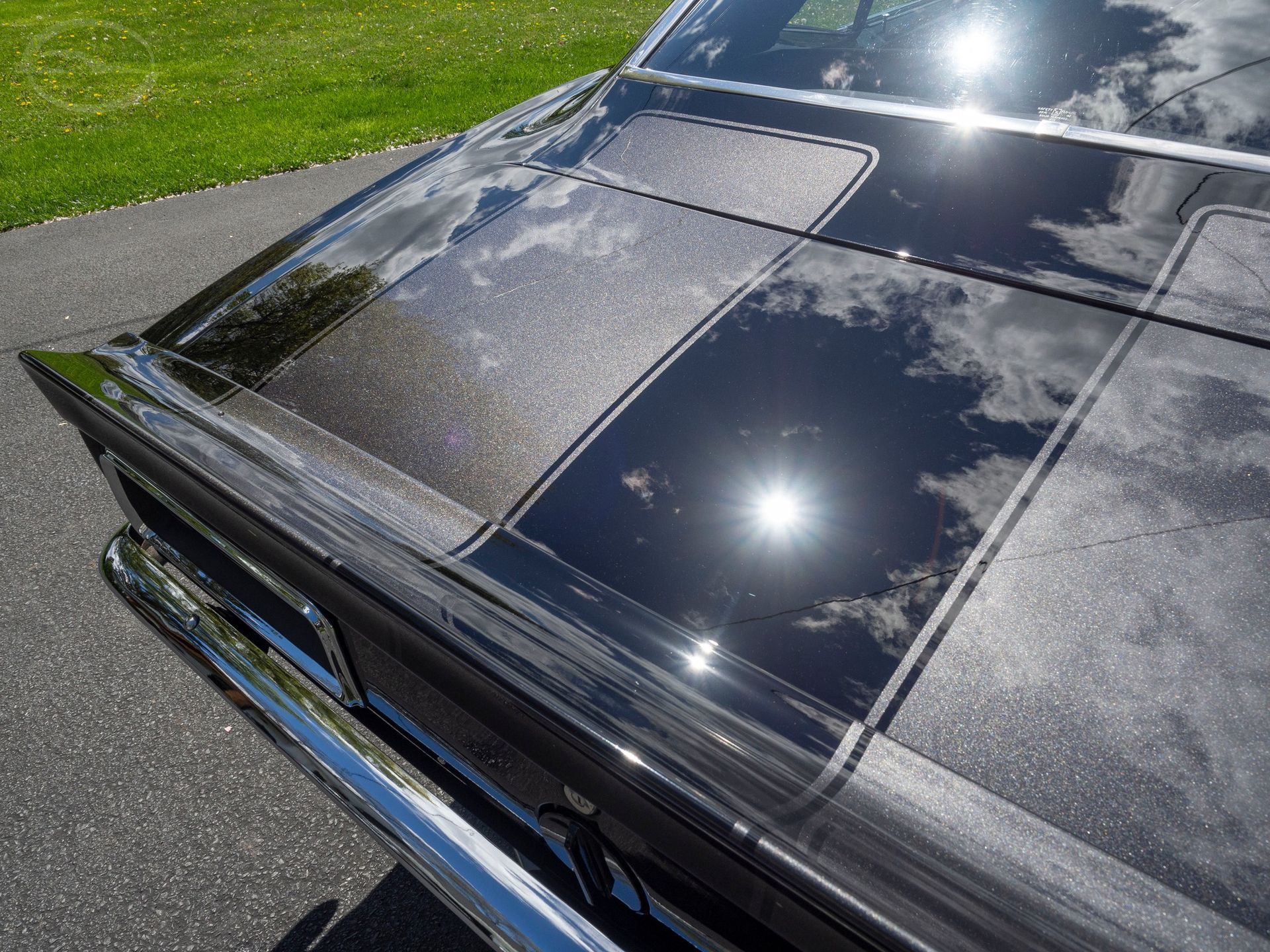 A close up of the hood of a black car.