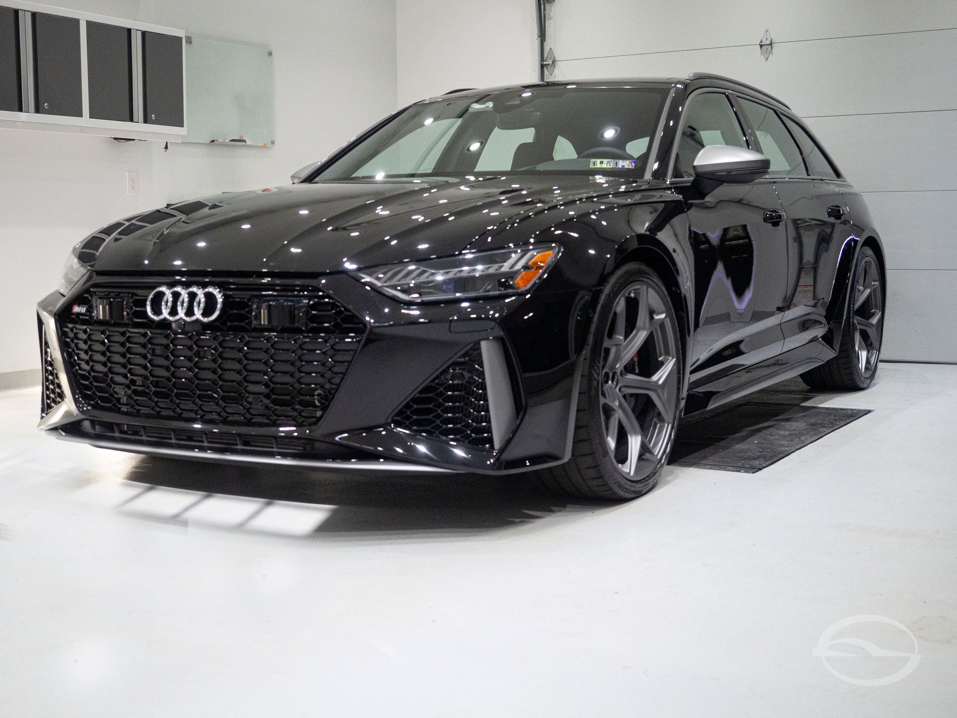 A black sports car is parked on the side of the road.