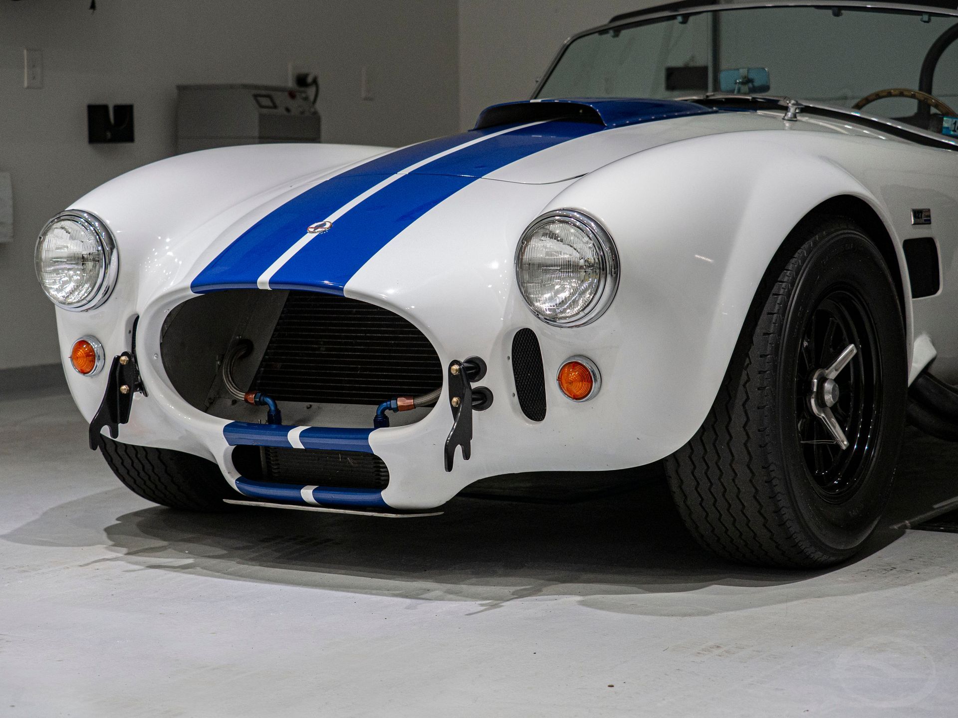 A gray porsche 911 gt3 is parked in a driveway.