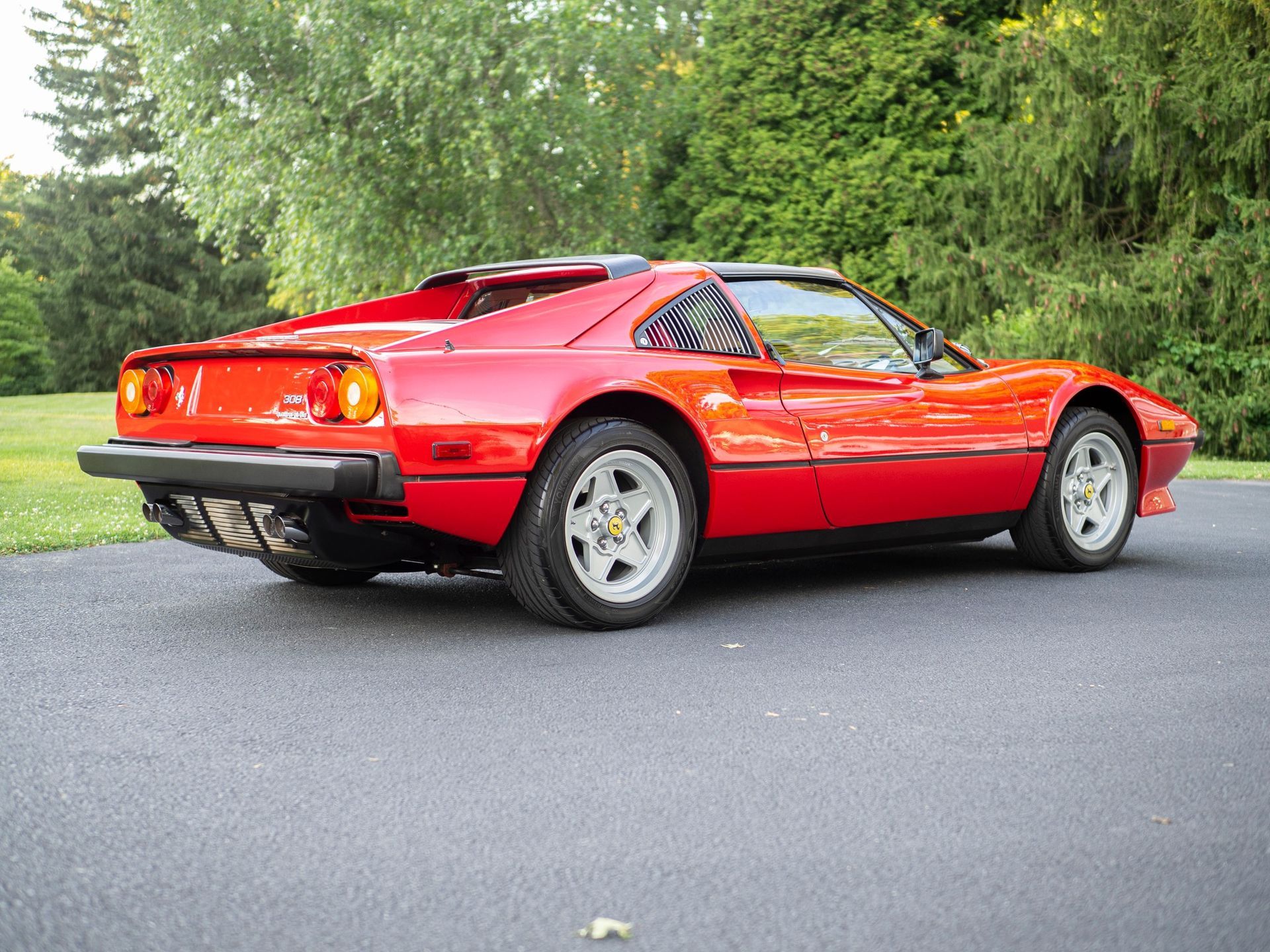 A red sports car is parked on the side of the road