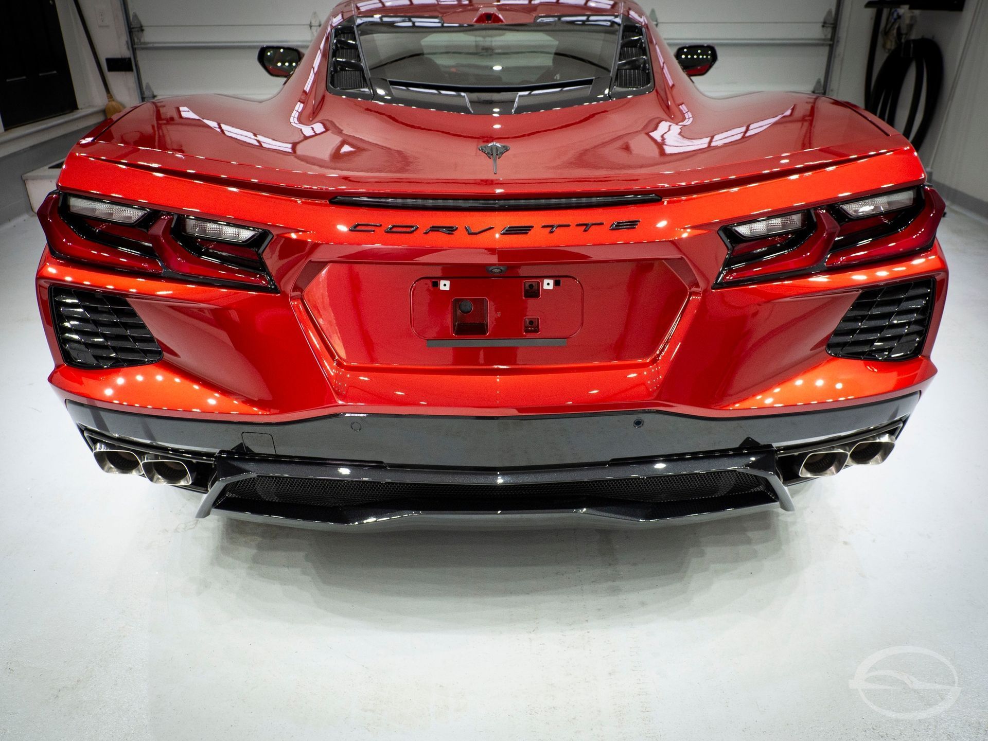 A red porsche turbo is parked in a garage.