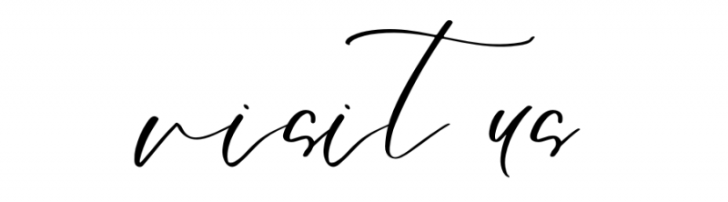 Handwritten black script reading “visit us” on a white background