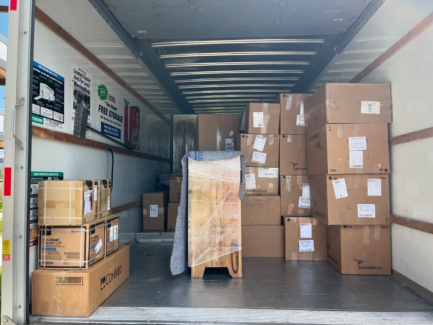 The inside of a moving truck filled with lots of boxes.