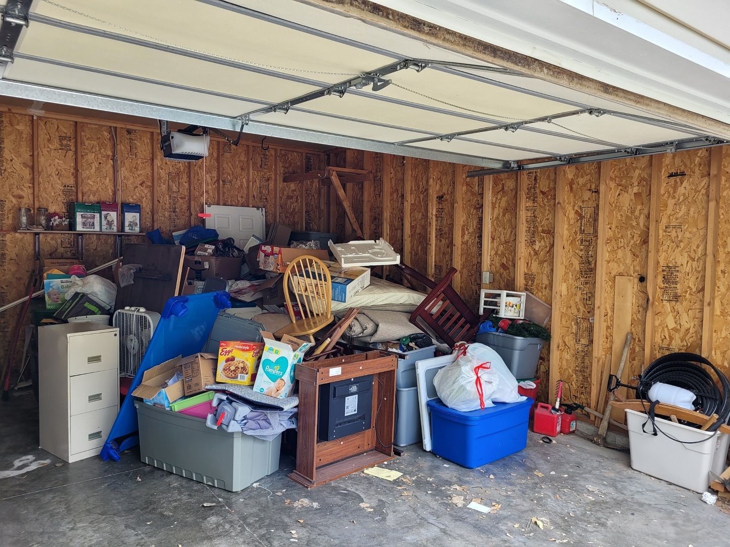 A garage filled with lots of junk and boxes.