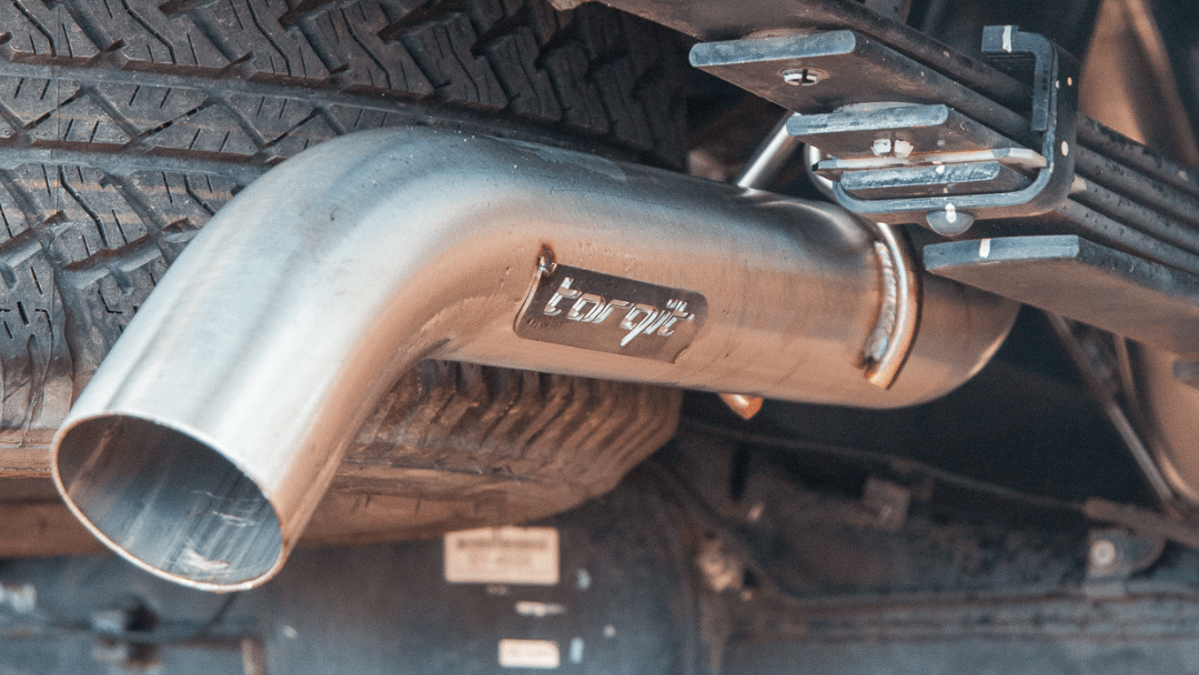 A close up of a exhaust pipe on the back of a truck.