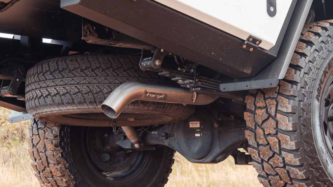 A close up of the underside of a truck with a exhaust pipe