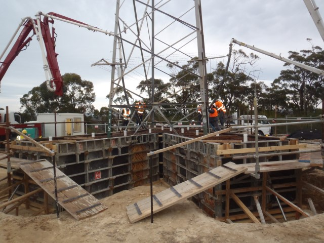A construction site with a concrete pump in the foreground