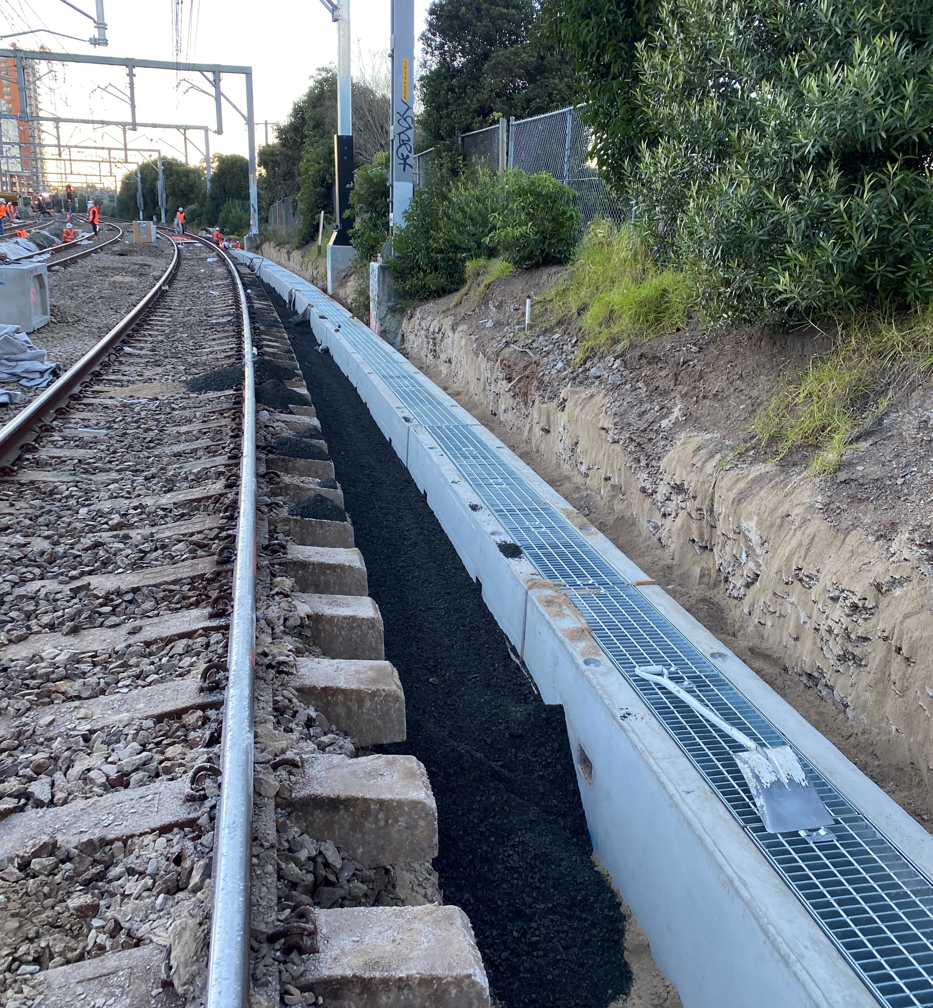 A train track with a concrete barrier along the side of it.