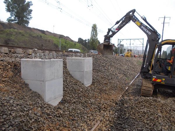 A volvo excavator is digging in a pile of gravel