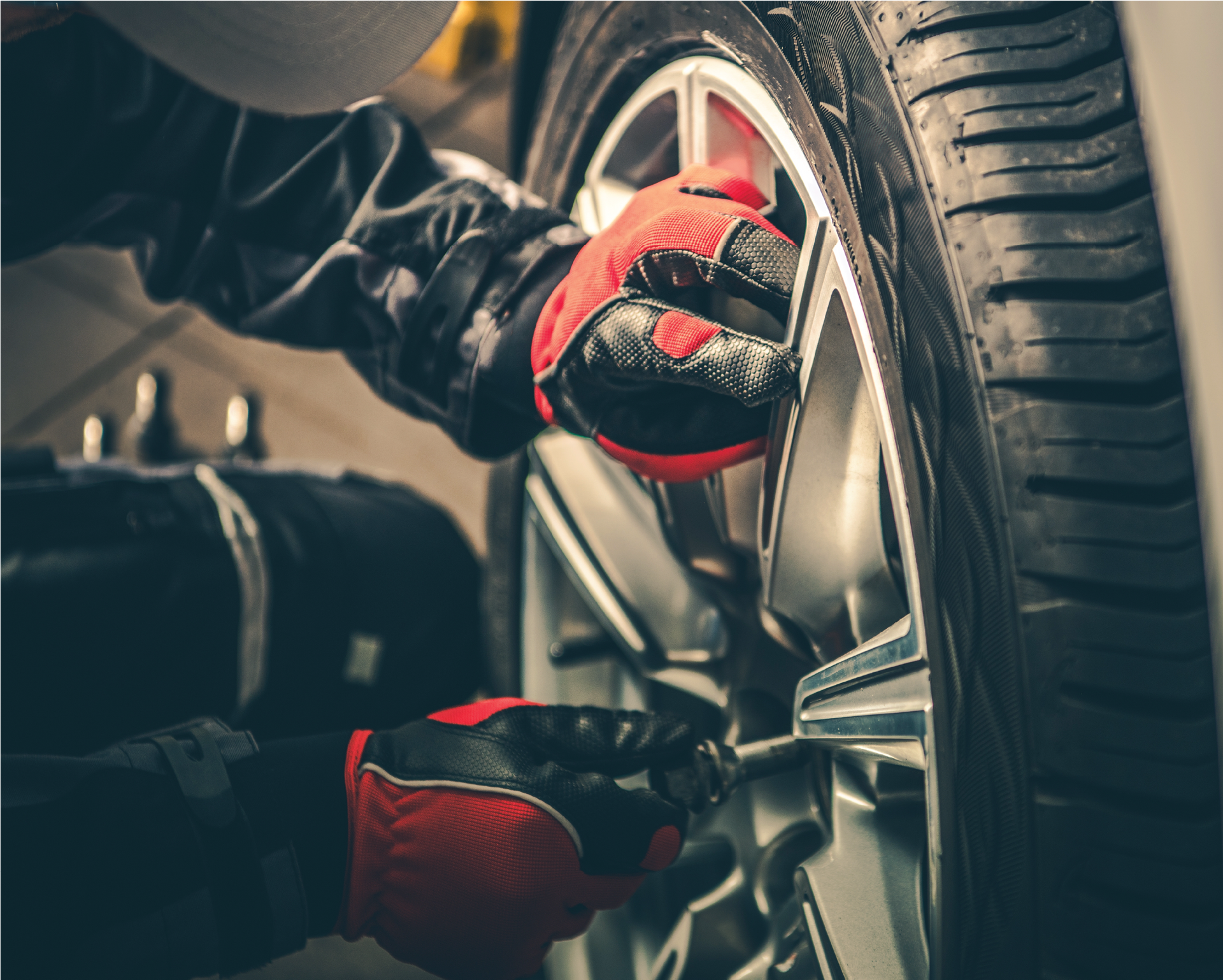 A person is changing a tire on a car.