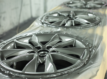 A row of silver wheels are sitting on a table