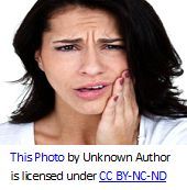 Woman grimacing with a toothache