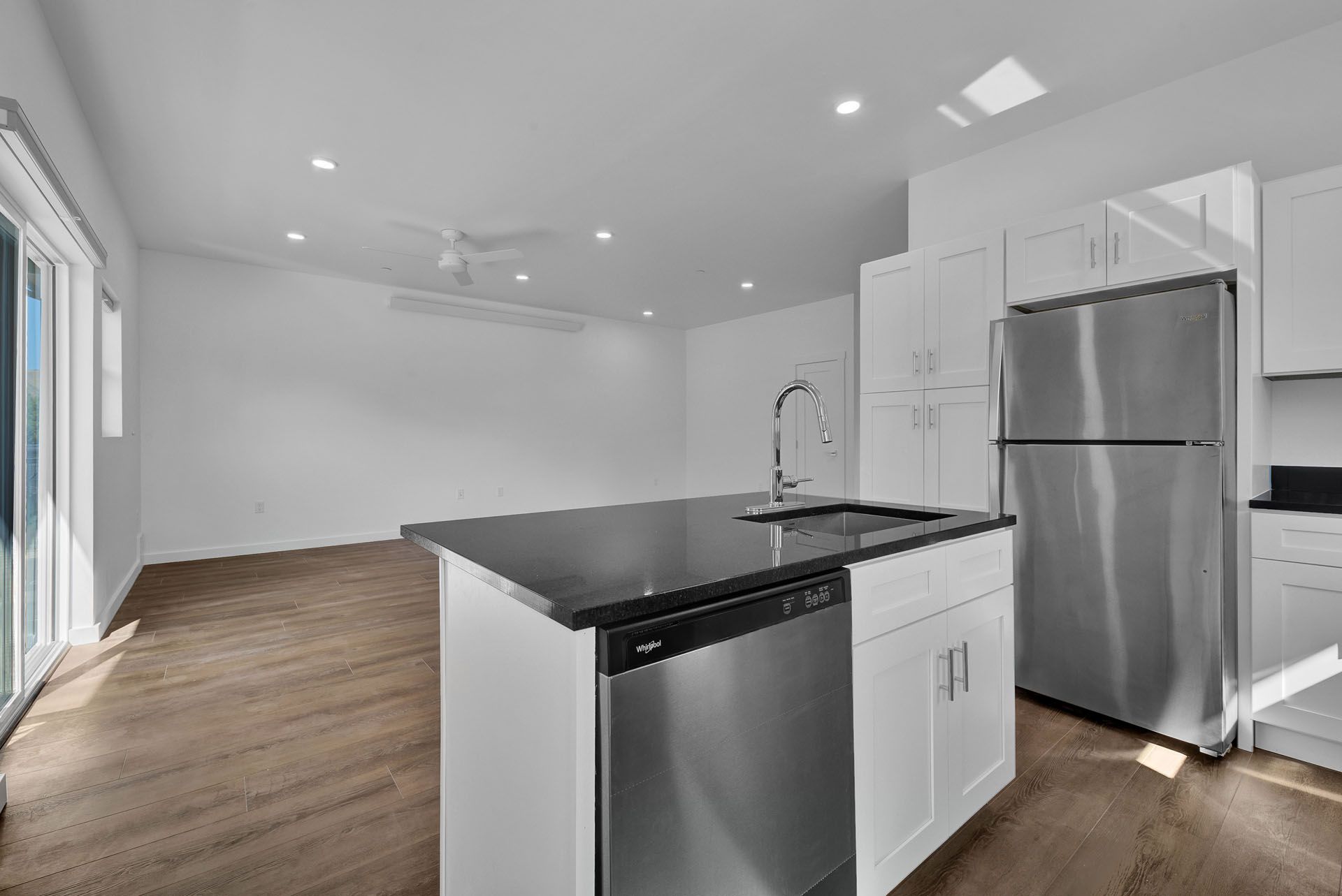 A kitchen with stainless steel appliances and a large island.