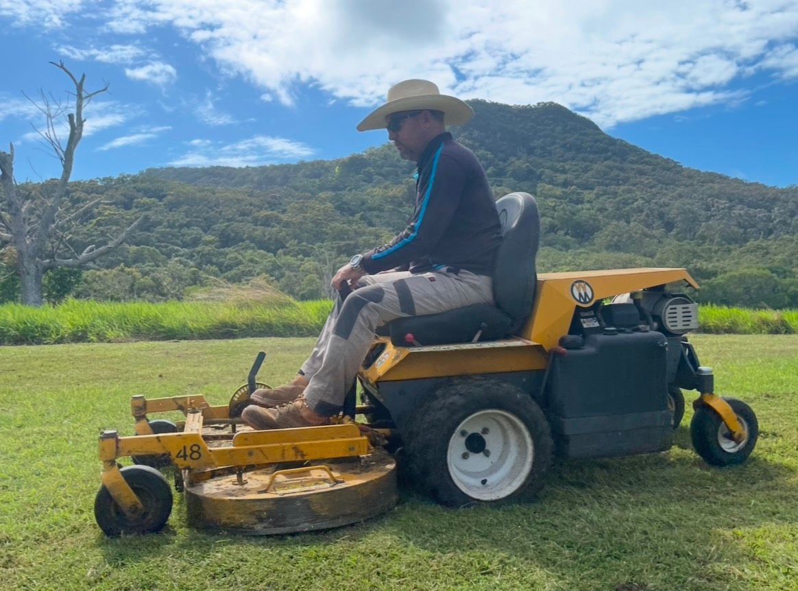A Man In A Cowboy Hat Is Sitting On A Lawn Mower — Everyday Maintenance Pty Ltd In Beaconsfield, QLD