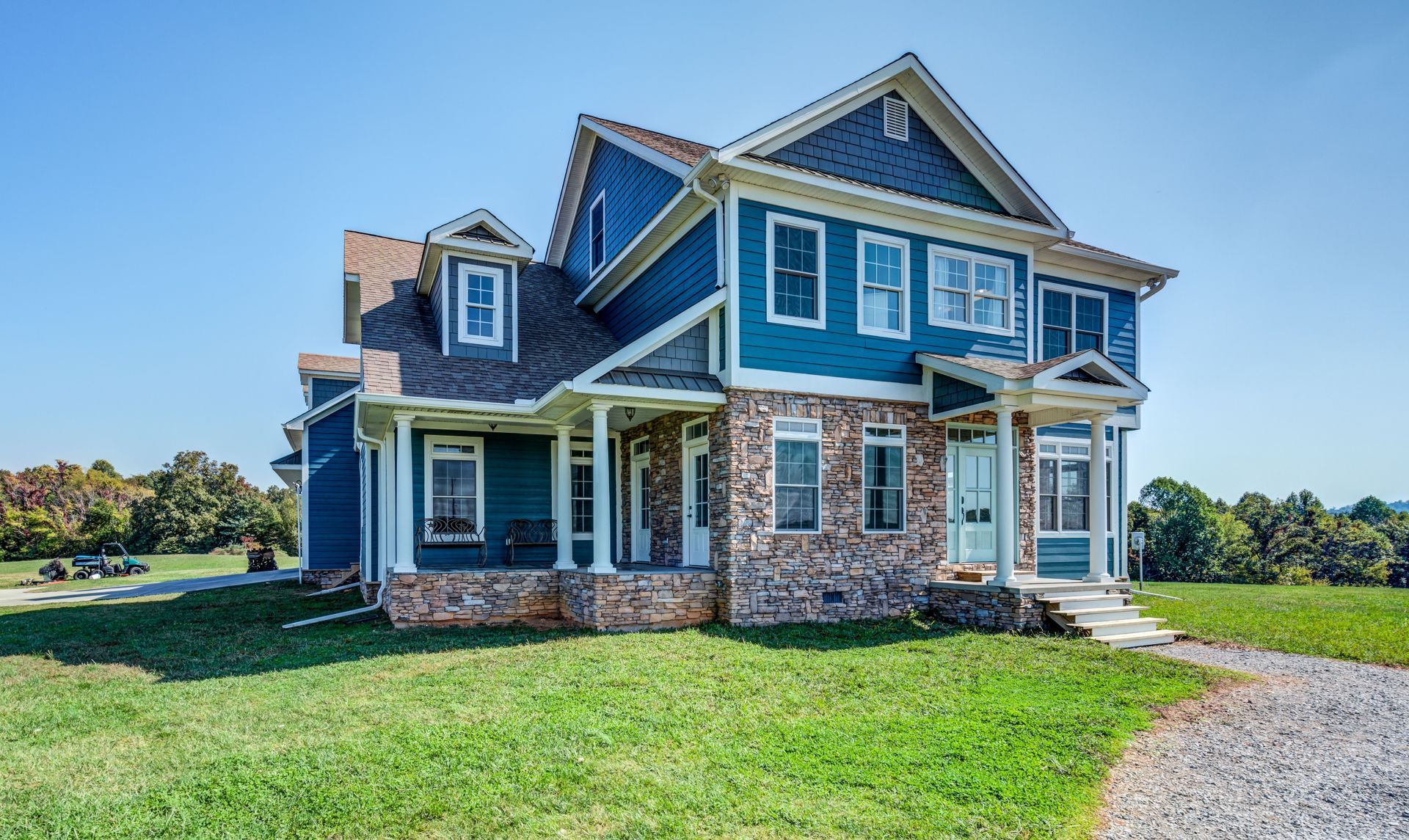 Empty living room with fireplace, wood floors, and French doors.