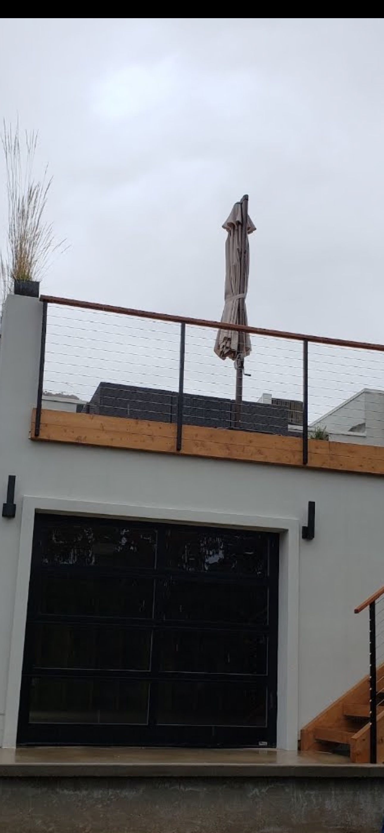 A balcony with an umbrella on top of it