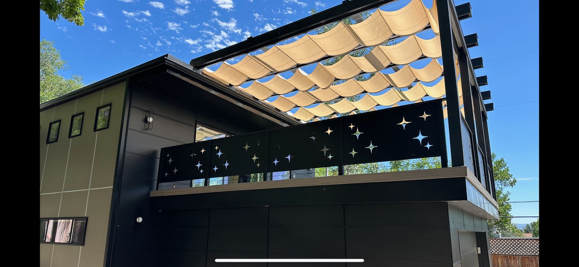 A house with a balcony and a canopy on the roof.