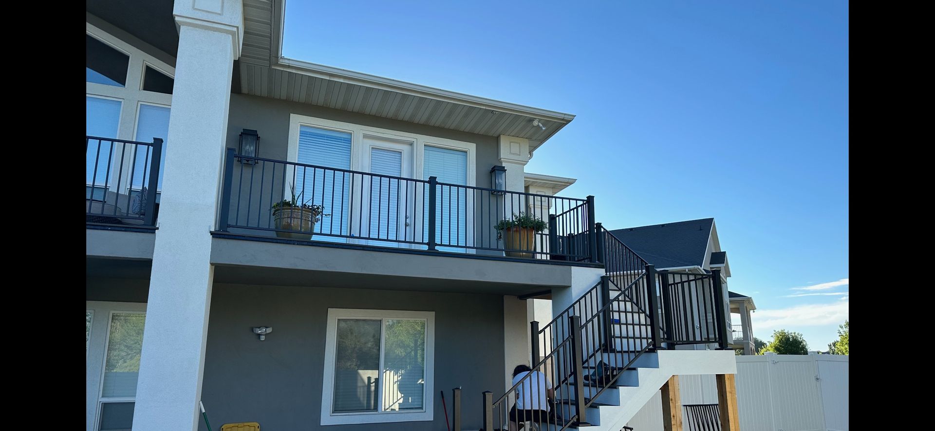 A large house with a balcony and stairs.