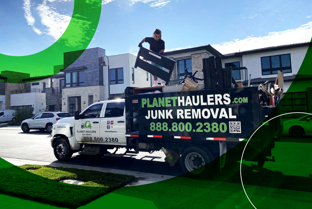 A junk removal truck is parked in front of a house.