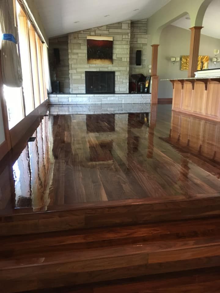 Close-up of various light-colored wood samples, including flooring and other pieces, showing grain and texture.