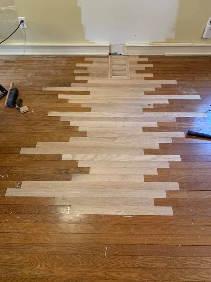 Weathered wooden deck planks, diagonal layout with a section of wood rot.