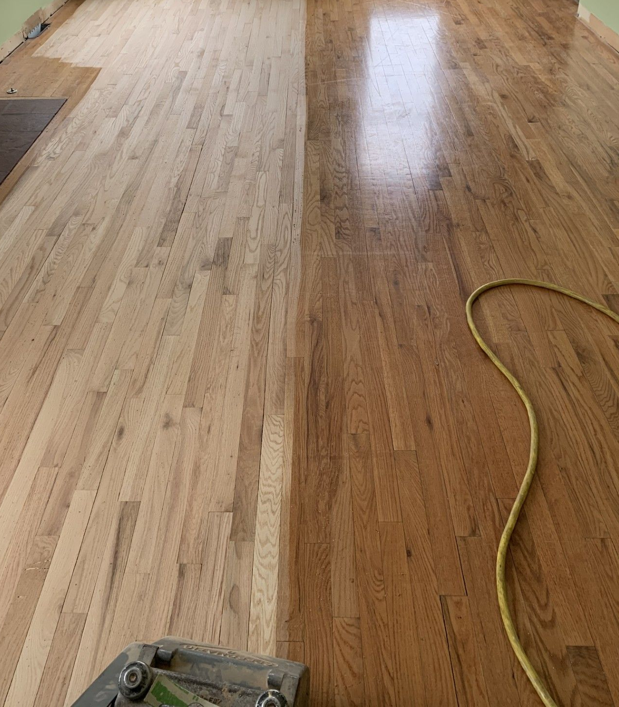 Herringbone wooden floor reflecting colorful light.