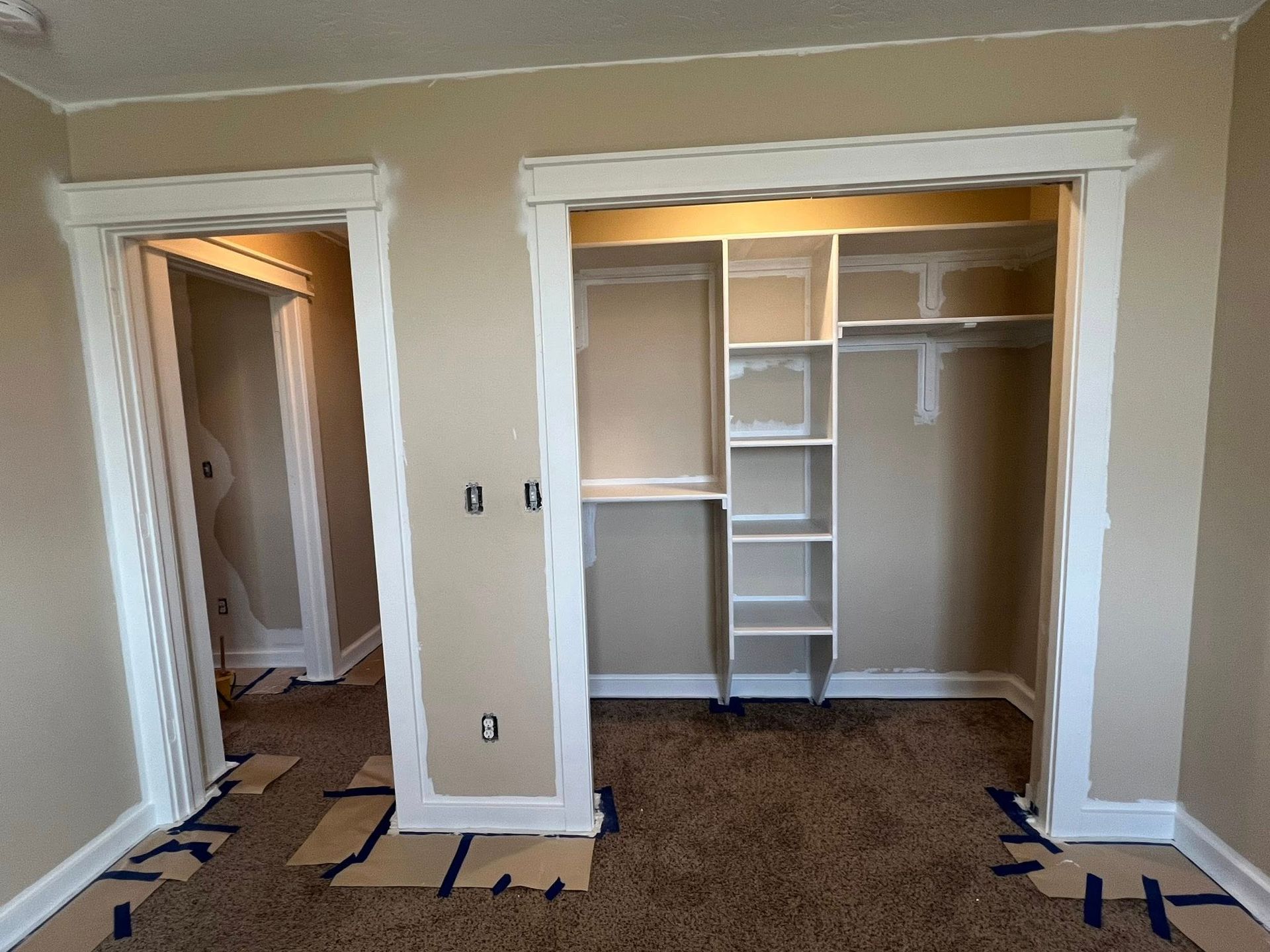 A room with a closet and shelves in it